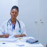 Doctor sitting at the table in front of a girl