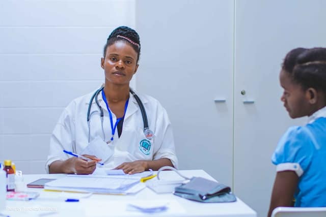 Doctor sitting at the table in front of a girl