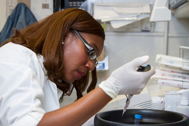 scientist holding pipette