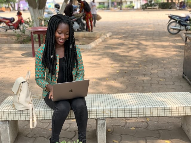student sitting and using laptop